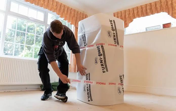 Albert Miles Removals mover wrapping furniture for protection