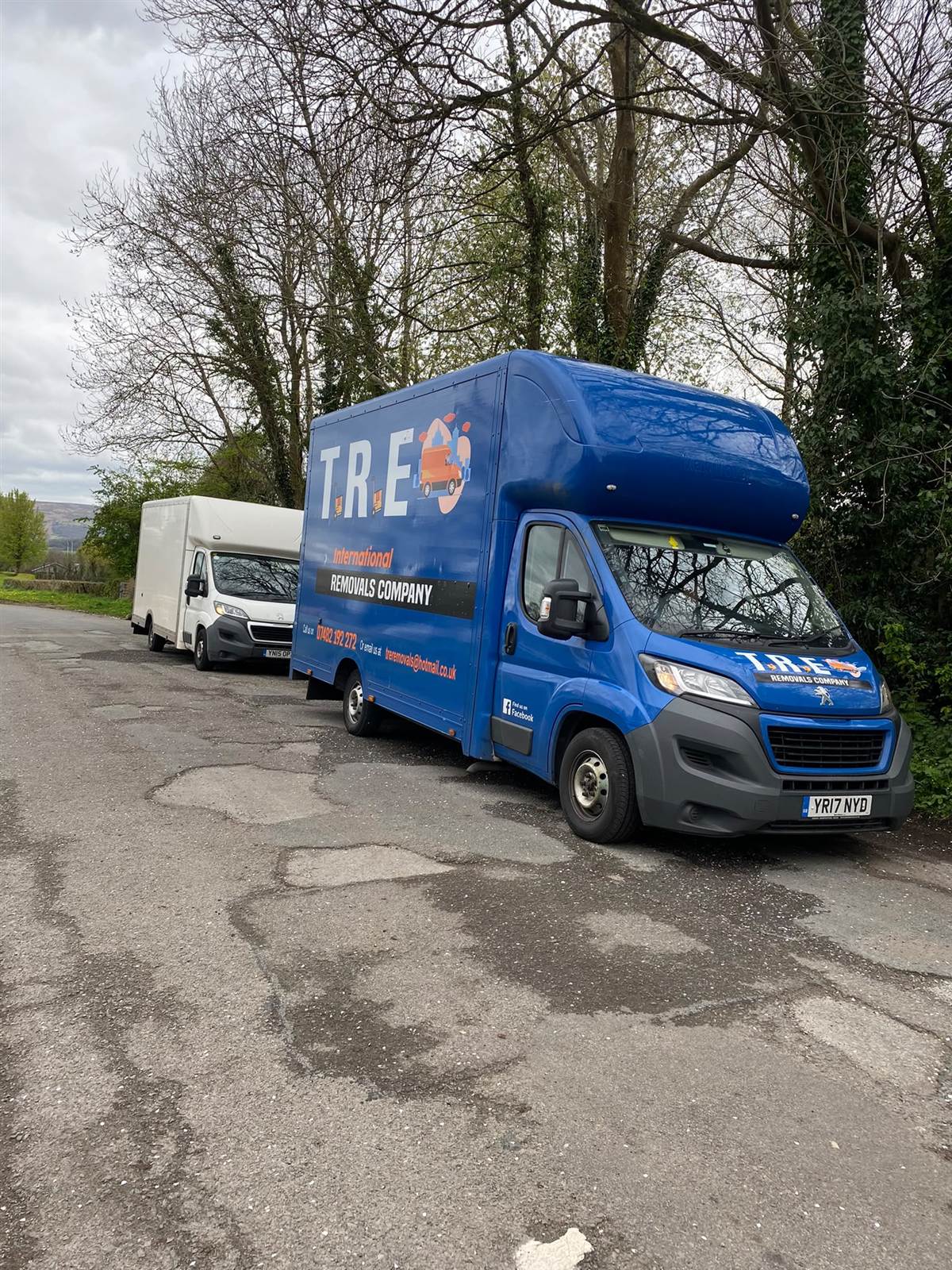 Man preparing for a house move by packing boxes into a removal vehicle