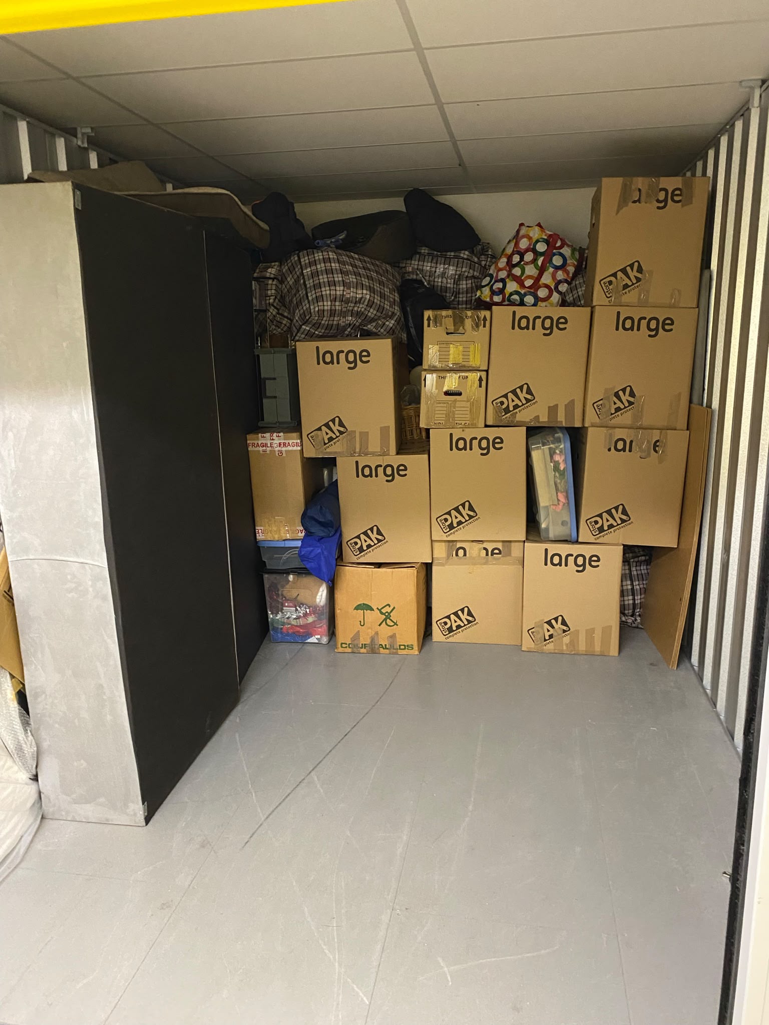 Professional office removal team moving furniture and boxes during a commercial relocation
