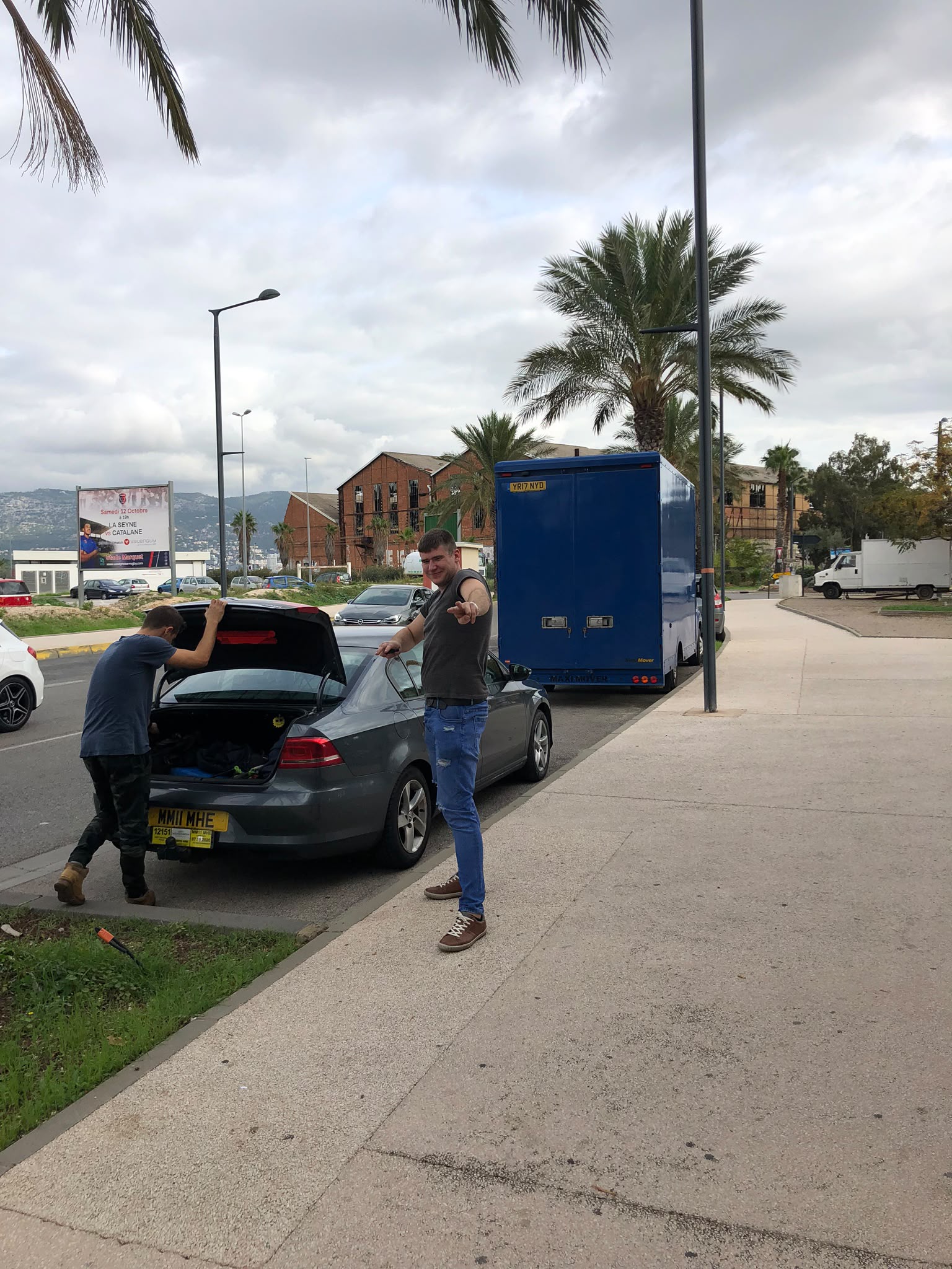 Student packing boxes and belongings for a university move with labelled packing materials